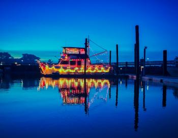 boat with yellow and red lights in water