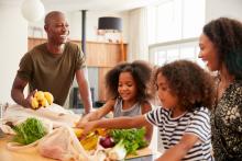 A family unloads their groceries in their vacation rental